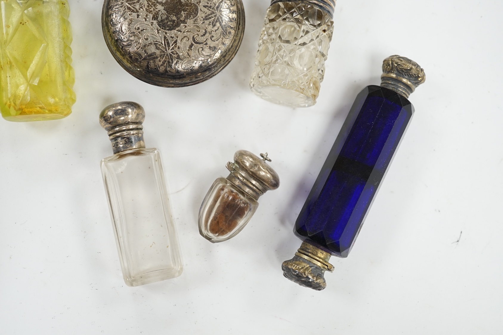 A George V engraved silver moon shaped scent bottle, James Dixon & Sons, Sheffield, 1912, together with five other white metal mounted glass scent bottles. Condition - poor to fair